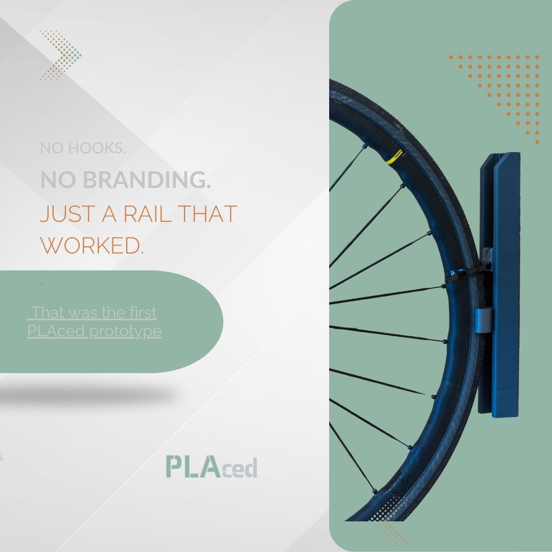 First PLAced prototype showing a bike wheel on the original unbranded wall rail with HO hook and cable tie, used for winter storage.