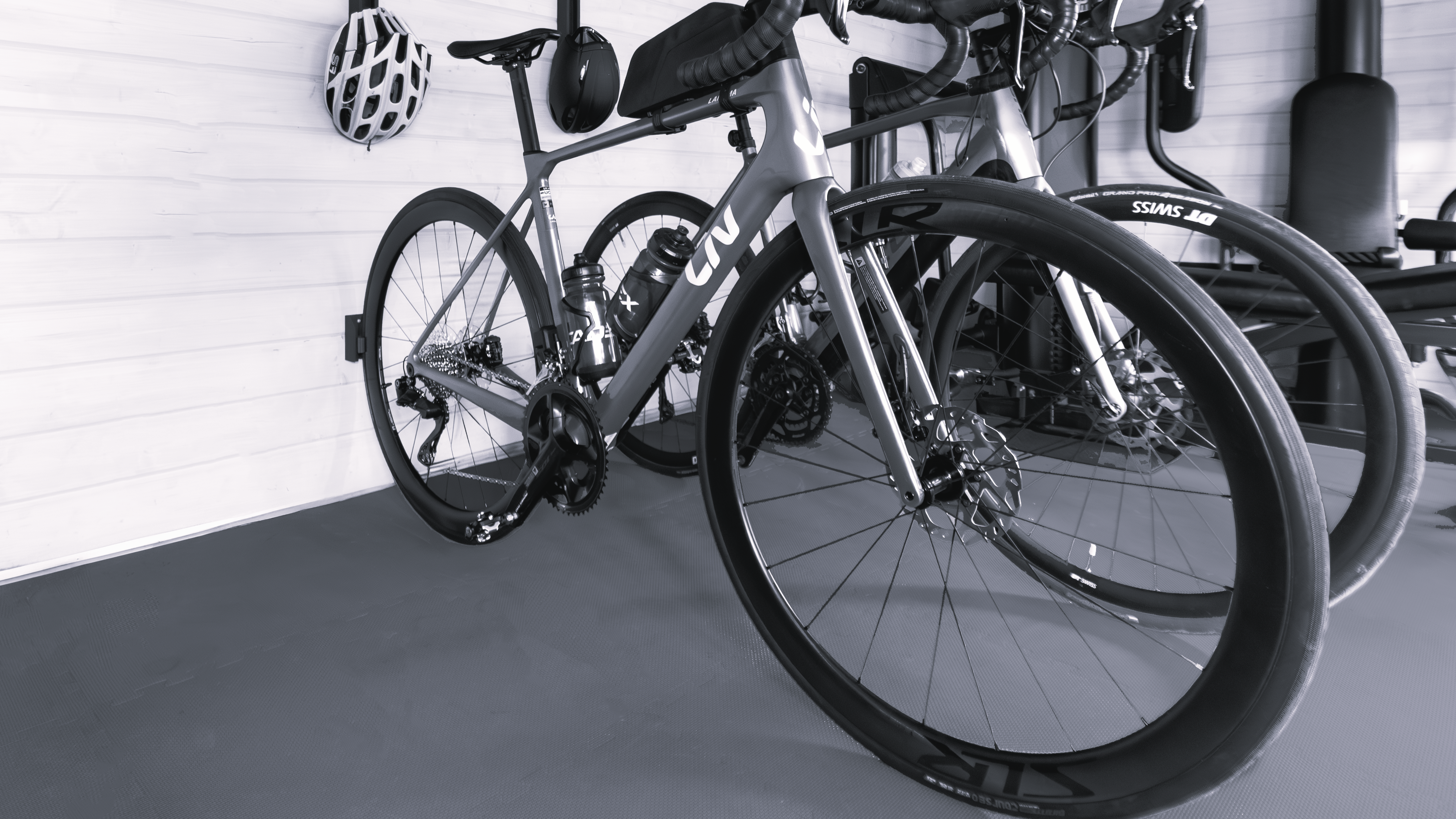 Image shows a bike placed horizontally using the placed upright system in a home garage. 